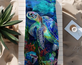 May include: A colorful beach towel featuring a detailed illustration of a sea turtle swimming in an underwater scene. The design includes vibrant blues, greens, and coral reef elements, creating a vivid and artistic depiction.