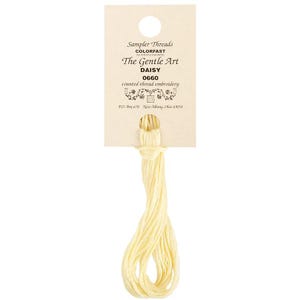 May include: A skein of pale yellow embroidery floss labeled "Sampler Threads Colorfast The Gentle Art Daisy 0660 counted thread embroidery PO Box 670 New Albany, Ohio 43054"