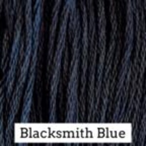 May include: A close-up view of dark navy blue embroidery floss or thread featuring a twisted fiber texture. A white rectangular label at the bottom contains the black printed text Blacksmith Blue, identifying the specific color shade.