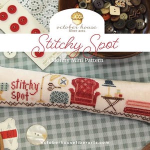 May include: A cross-stitch pattern with the words "Stitchy Spot" and various sewing-themed illustrations. The design includes a red armchair, a lamp, and a table. The background features buttons and fabric.