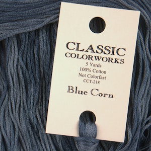 May include: A skein of blue cotton embroidery floss with a label that reads "CLASSIC COLORWORKS 5 Yards 100% Cotton Not Colorfast CCT-218 Blue Corn"