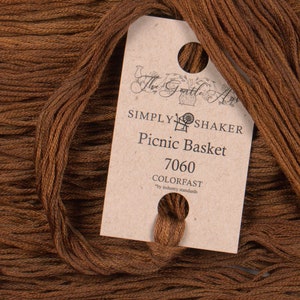 May include: A skein of brown embroidery floss with a label that reads "The Gentle Art, Simply Shaker, Picnic Basket, 7060, Colorfast *by industry standards".