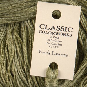 May include: A skein of green embroidery floss with a label that reads "CLASSIC COLORWORKS 5 Yards 100% Cotton Not Colorfast CCT-139 Eve's Leaves"
