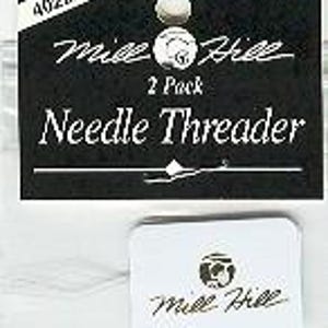 May include: A Mill Hill 2 Pack Needle Threader in a clear plastic package. The black header card features the text 40222, Mill Hill, 2 Pack, and Needle Threader. A small white rectangular tag with the Mill Hill logo is visible inside the packaging.