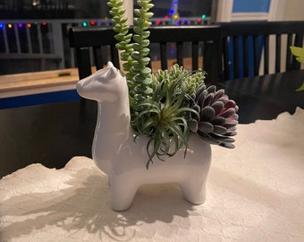 Llama planter with fake succulents