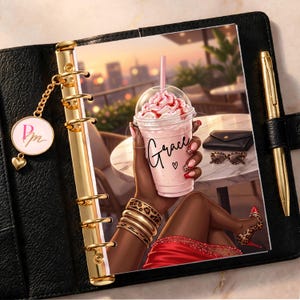 May include: A black leather binder with gold rings and a gold pen. The cover features an illustration of a person holding a pink iced drink labeled Grace, wearing leopard print bracelets and heels, with a small black clutch and sunglasses nearby.