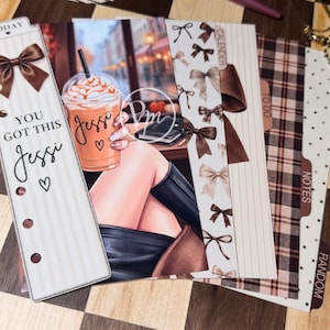 May include: A set of planner dividers and bookmarks featuring brown bows, plaid patterns, and a graphic illustration of a person holding an orange iced coffee. The text includes "TODAY", "YOU GOT THIS", "Jessi", "CALENDER", "TO DO", "NOTES", and "RANDOM".