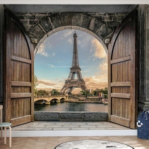 May include: A scenic wall mural depicting the Eiffel Tower in Paris, France, framed by a stone archway and wooden doors. The image captures a view of the Seine River and a bridge under a sunset sky, creating a travel-themed aesthetic.