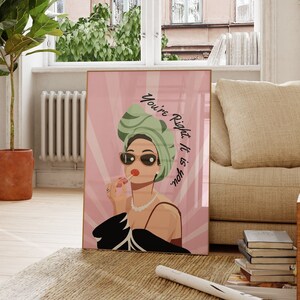 May include: A pink and white poster with a woman wearing a green turban and sunglasses. The text on the poster reads "You're Right, It Is About You."