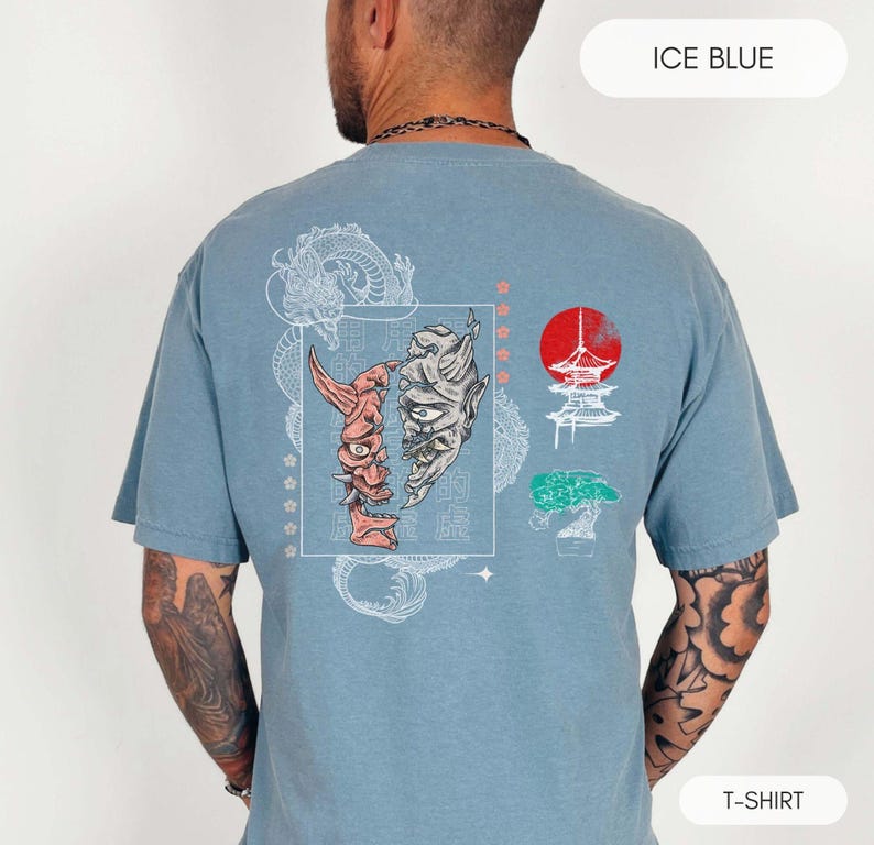 May include: A light blue t-shirt with a graphic print of a Japanese demon mask, a pagoda, a bonsai tree, and a dragon. The text "ICE BLUE" is in the top right corner and "T-SHIRT" is in the bottom right corner.