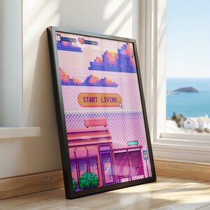 May include: A framed pixel art print with a pink, purple, and blue color scheme. The print features a pixelated cityscape with a building that says "Start Living" and a pixelated sky with clouds.