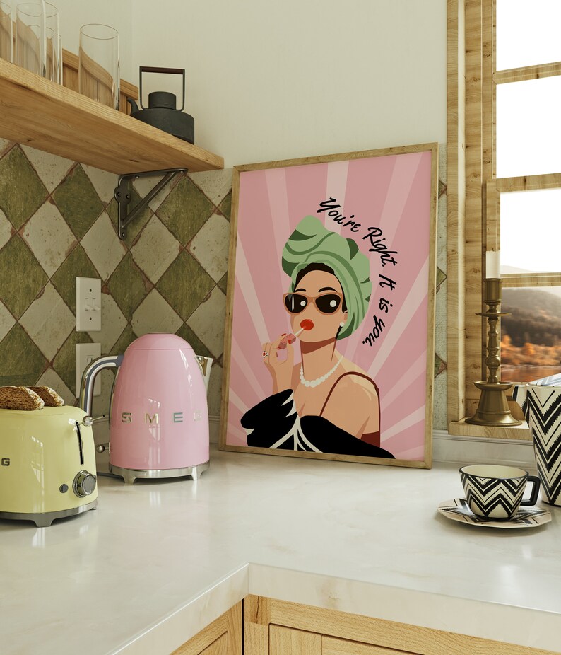 May include: Pink and black framed print with a woman wearing sunglasses and a green headscarf. The text on the print reads "You're Right, It is You."