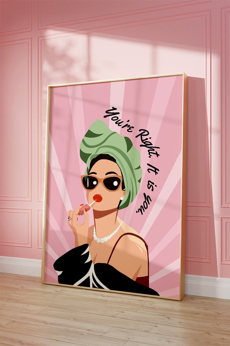 May include: A pink and white illustration of a woman wearing sunglasses, a green turban, and a black dress. She is applying lipstick and the text "You're Right. It is you." is written in black on the pink background.