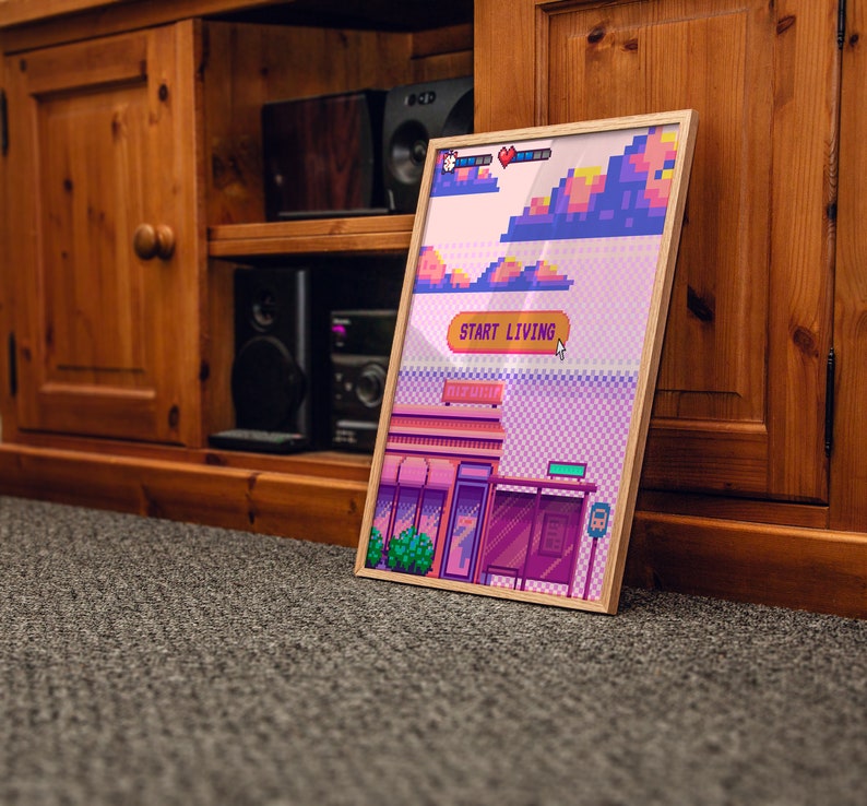 May include: A framed pixel art print with a pink, purple, and blue color scheme. The print depicts a building with a sign that reads "Start Living".