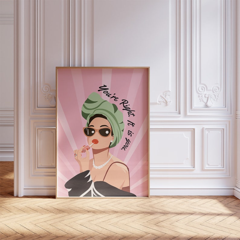 May include: A pink and white poster with a woman wearing a green turban and sunglasses. The text on the poster reads "You're Right. It is you."