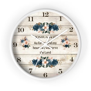 May include: White wall clock with a light wood grain effect. The clock face features floral arrangements in blue, peach, and white. The text "JOSHUA 24:15" and a quote are centered on the clock face.