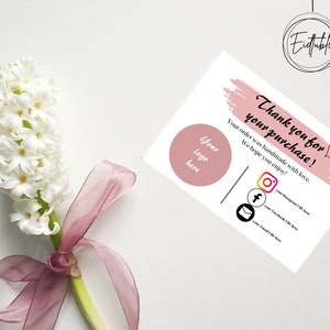 May include: A white thank you card with a pink brushstroke design. The text "Thank you for your purchase!" is written in black. The card also includes a space for a logo, social media icons, and the text "Your order was handmade with love. We hope you enjoy!"
