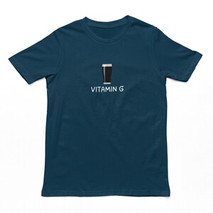 May include: A dark blue t-shirt with a white graphic of a pint of beer and the text "Vitamin G".