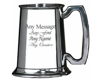 May include: A silver stainless steel tankard with a handle. The tankard has an inscription that reads "Any Message Any Font Any Name Any Occasion".