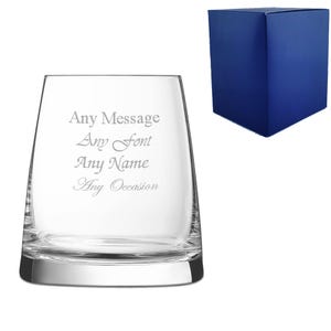 May include: A clear glass tumbler with a square base and rounded sides. The glass is engraved with the text "Any Message Any Font Any Name Any Occasion". The glass is packaged in a blue box.
