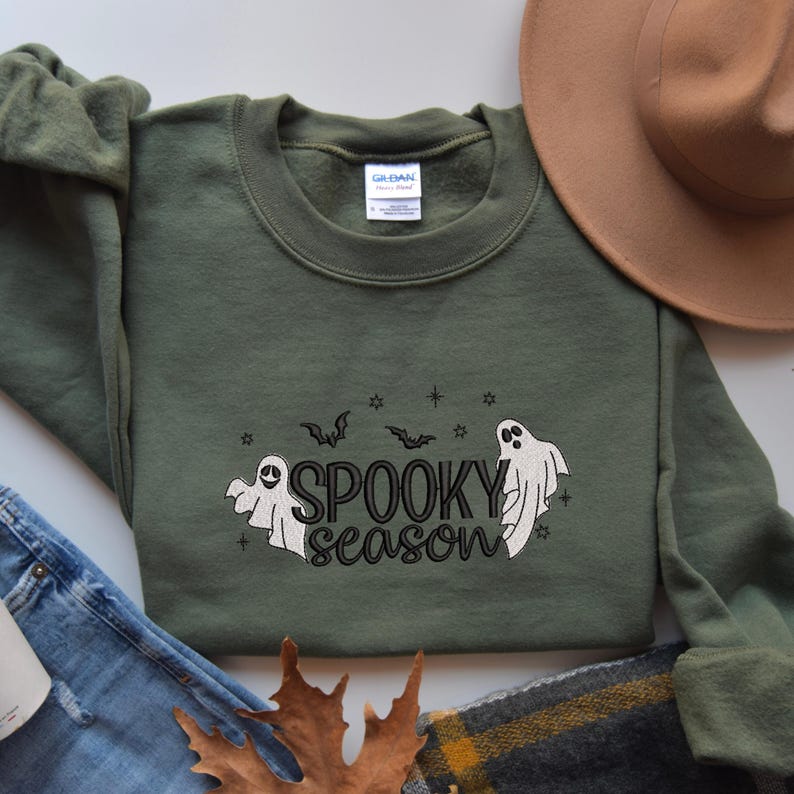May include: A green sweatshirt with a white ghost graphic and the text "Spooky season" in black.