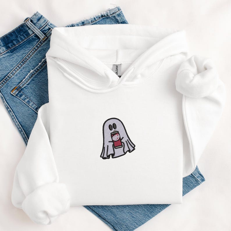 May include: White hoodie with a ghost holding a can of soda embroidered on the front.