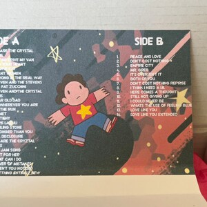 May include: A cassette tape insert featuring a cartoon character and song titles. The design has a space theme with stars and a color palette of red, blue, and purple. The text includes song titles from Side A and Side B.
