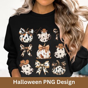 May include: A black sweatshirt with a Halloween design featuring nine images of pumpkins, ghosts, and bows. The pumpkins and ghosts are decorated with a black and white spotted pattern. The bows are brown and white with a leopard print.