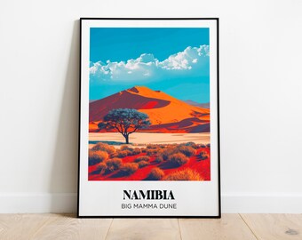 May include: A framed print of a desert landscape in Namibia, featuring a large orange sand dune with a lone tree in the foreground. The text "NAMIBIA BIG MAMMA DUNE" is printed at the bottom of the print.