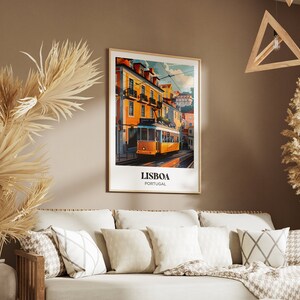 May include: A framed poster with a vintage travel illustration of a yellow tram in Lisbon, Portugal. The poster has the text "LISBOA PORTUGAL" at the bottom.