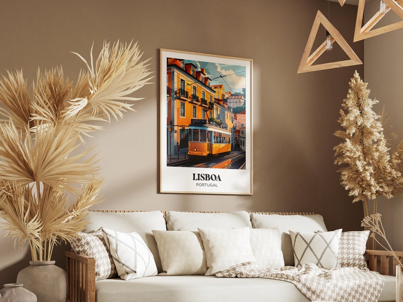 May include: A framed poster with a vintage travel illustration of a yellow tram in Lisbon, Portugal. The poster has the text "LISBOA PORTUGAL" at the bottom.