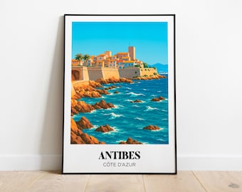 Puede incluir: Una impresión artística enmarcada que representa Antibes, Francia. La obra de arte muestra edificios costeros, un cielo azul claro y agua turquesa. La impresión incluye el texto "ANTIBES CÔTE D'AZUR" en la parte inferior.