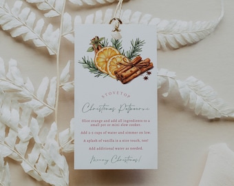 Peut inclure: Une carte blanche avec une recette manuscrite pour un pot-pourri de Noël. La carte présente une illustration aquarelle de tranches d'orange, de bâtonnets de cannelle et d'anis étoilé. Le texte indique "Pot-pourri de Noël pour la cuisinière" et comprend des instructions pour faire le pot-pourri.