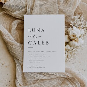 May include: A white wedding invitation with black text. The invitation reads "LUNA and CALEB" and invites guests to celebrate their wedding on Saturday, June 12th, at 3 o'clock in the afternoon at Victorian Rose Manor in London, England. The words "reception to follow" are at the bottom.