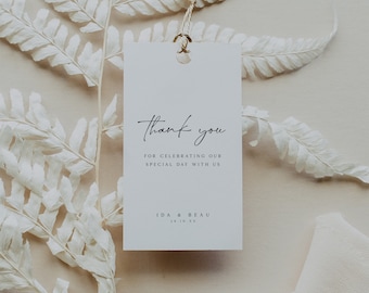 May include: White thank you tag with black calligraphy that reads "Thank you for celebrating our special day with us Ida & Beau 28.10.23".