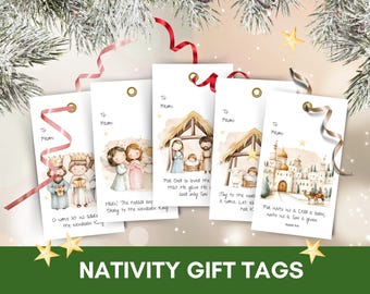 May include: Set of five white Nativity gift tags with watercolor illustrations of the Nativity scene. Each tag has a gold eyelet and a ribbon. The tags feature images of the Three Wise Men, angels, and the Holy Family. Text includes "To From" and Bible verses.
