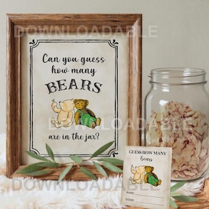 Pode incluir: Uma placa emoldurada com o texto "Can you guess how many BEARS are in the jar?" e um cartão de jogo correspondente. A placa e o cartão apresentam ilustrações de dois ursinhos de pelúcia. Um frasco de vidro cheio de guloseimas também é visível.