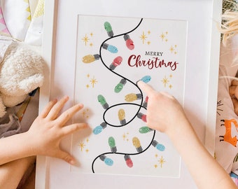 May include: White framed print with a Christmas lights design. The lights are made of colorful fingerprints, with the words "MERRY Christmas" in burgundy script. The print is held by a child's hands.