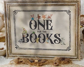 May include: A rustic wooden framed sign with a beige background and black text that reads "One for the Books". The sign features illustrations of characters from children's books, including Winnie the Pooh, Peter Rabbit, and The Very Hungry Caterpillar.