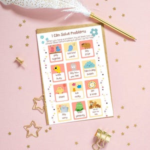 May include: A card with the text "I Can Solve Problems" and illustrated problem-solving steps. The card is on a pink surface with gold star confetti, a gold pen, and a decorative feather.