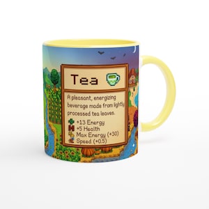 May include: A yellow-handled mug with a wrap-around design depicting a landscape with a river, trees, and a house. The mug features the word "Tea" and details about the beverage.