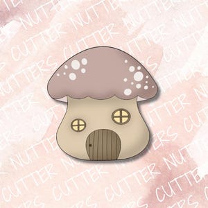 May include: A brown and white mushroom house cookie cutter with two windows and a door. The cookie cutter is designed to create a mushroom-shaped cookie.