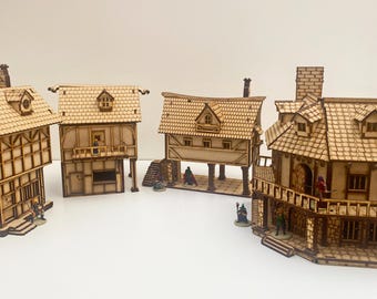 May include: Four wooden model buildings with intricate details, including windows, doors, and roofs. The buildings are painted in a natural wood colour and are arranged on a white surface.