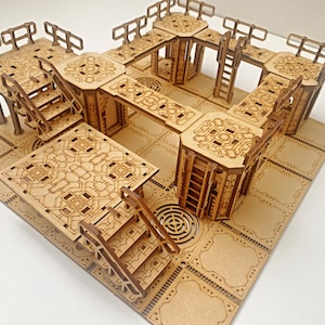May include: A wooden model of a multi-level structure with intricate details, featuring multiple platforms, stairs, and railings. The model is made of light brown wood and has a detailed design.