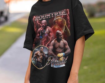 May include: A black short-sleeve t-shirt featuring a graphic print of a fighter. The design includes the text ROUNTREE and Khalil, with three images of the athlete in various poses against a background of red lightning bolts.