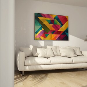 May include: A white couch with pillows in a living room with a colorful abstract geometric painting on the wall.
