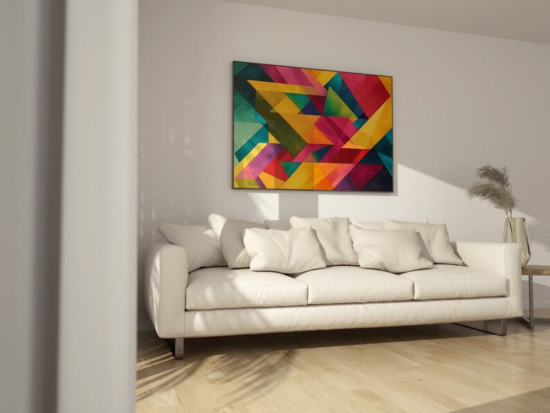 May include: A white couch with pillows in a living room with a colorful abstract geometric painting on the wall.