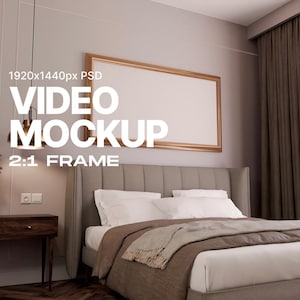 May include: A bedroom interior with a large, horizontal, gold-framed video screen mockup on the wall above a bed with white linens and a brown blanket. The text "VIDEO MOCKUP" is written in white letters on the wall below the screen. The text "1920x1440px PSD" is written in white letters on the wall above the screen. The text "2:1 FRAME" is written in white letters on the wall below the screen.
