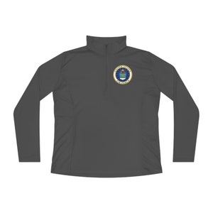 Könnte beinhalten: Ein dunkelgraues Langarmshirt mit Reißverschluss am Kragen und dem gestickten Siegel der US Air Force auf der Brust.