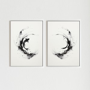 May include: Two framed black and white ink paintings of a fish jumping out of a circle of water. The fish is in the left painting, and the right painting is empty.